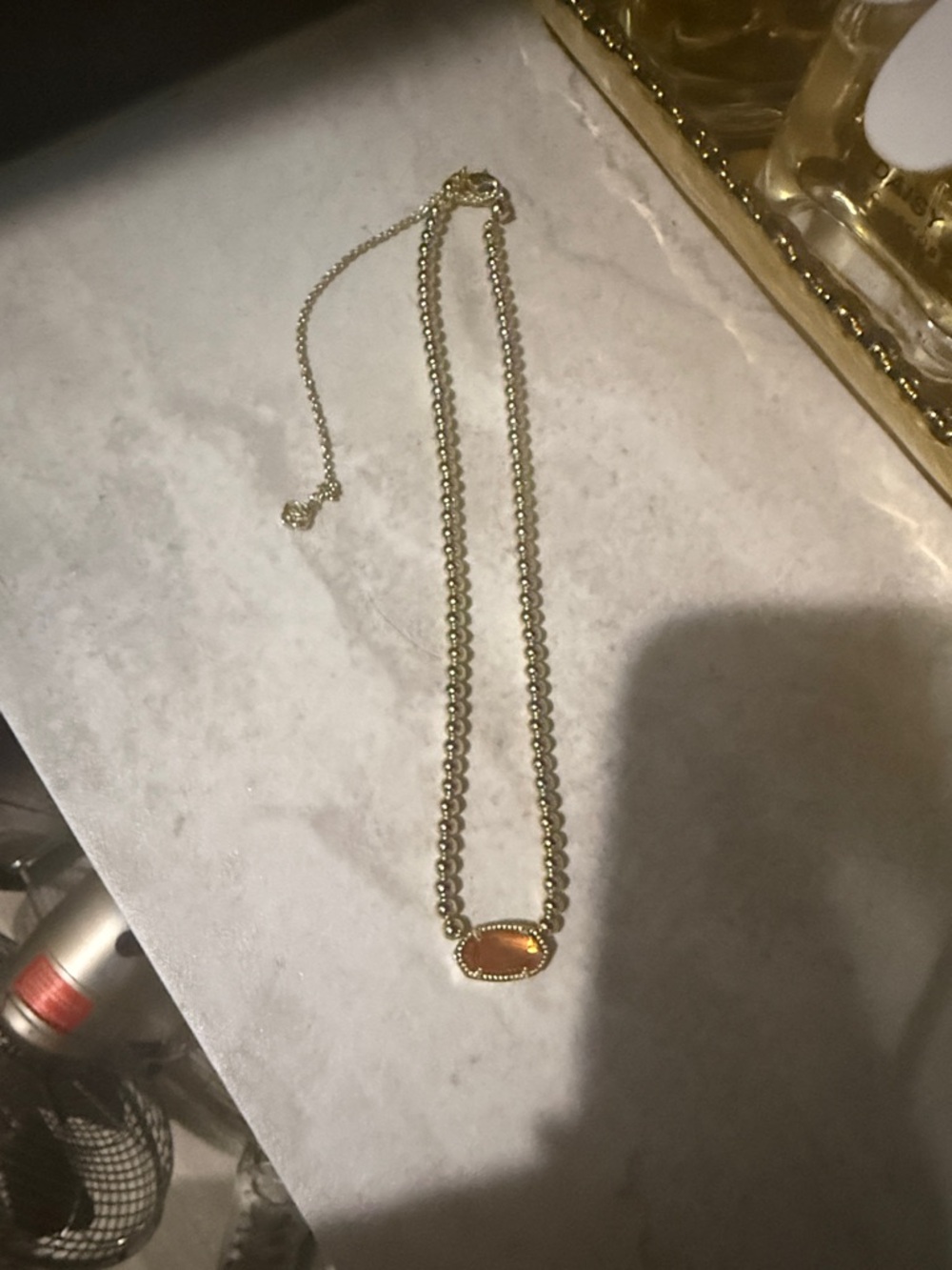 Kendra Scott necklace with orange stone. Never worn